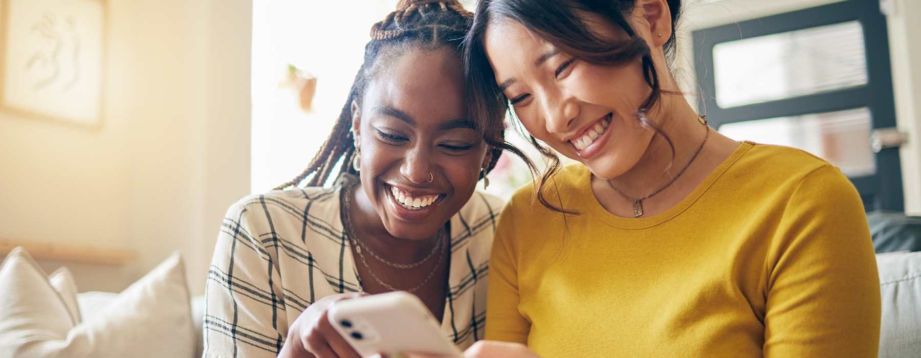two ladies looking at a phone