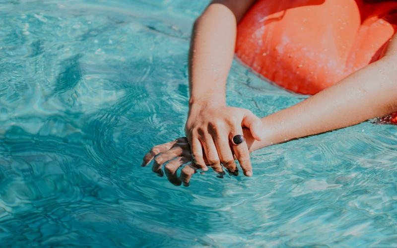 woman relaxes on a floatie in swimming pool