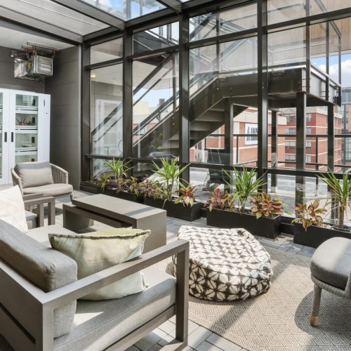 Settle into comfort at Trellis House a living room with a large glass wall and a large window