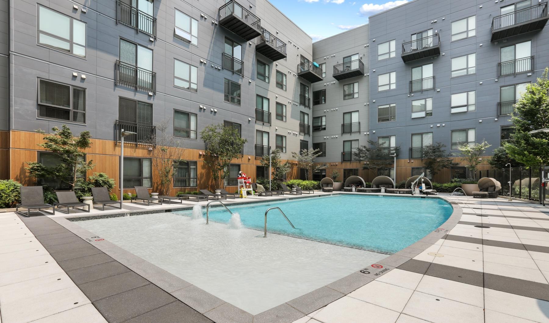 Settle into comfort at Trellis House a swimming pool in a courtyard between buildings