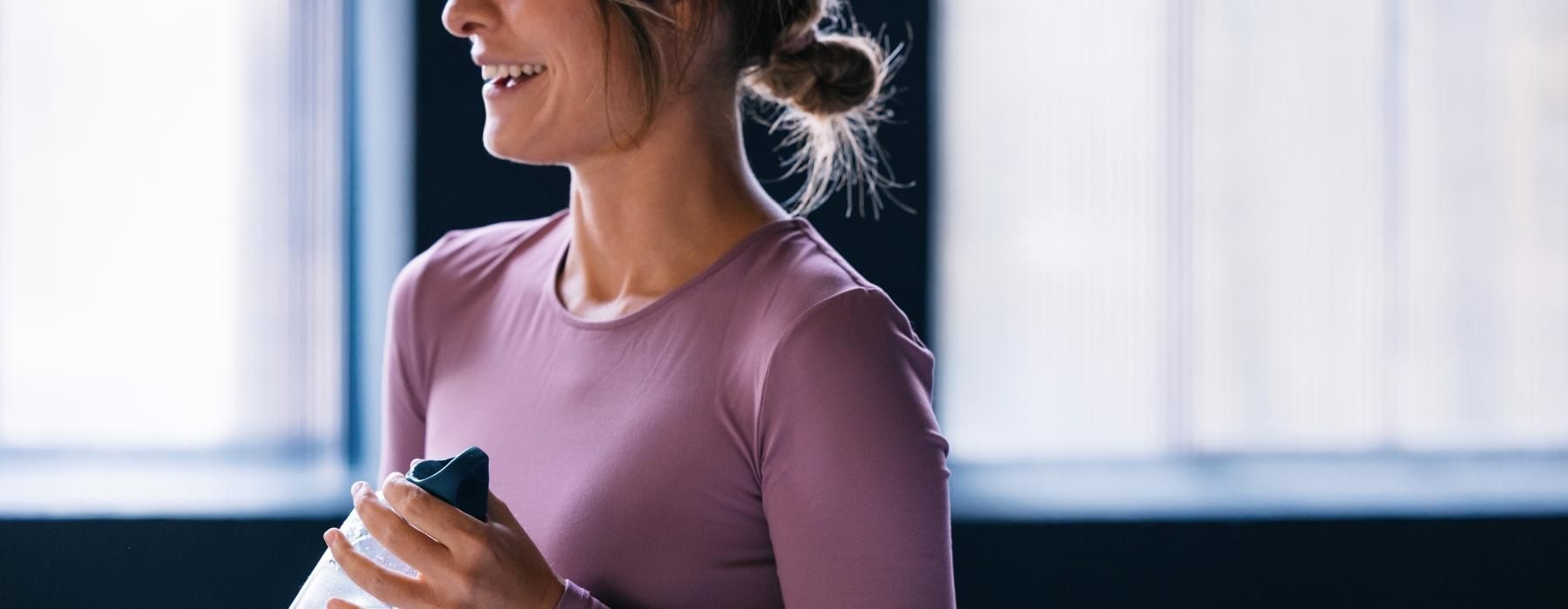 a woman holding a water bottle